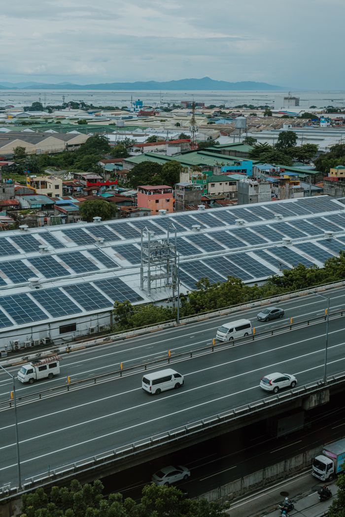Mastering the First Impression: Your intriguing post title goes here Urban landscape with solar panels and highway, showcasing renewable energy and modern infrastructure.